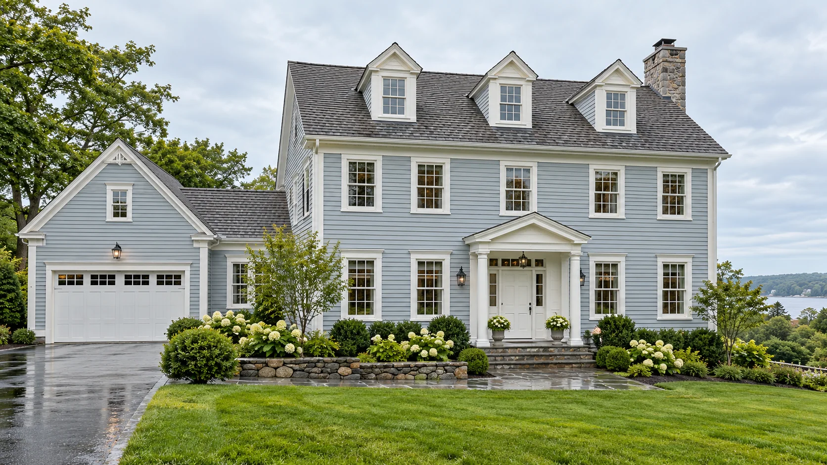 Illustration of a finished New England home with blue-gray siding and white trim